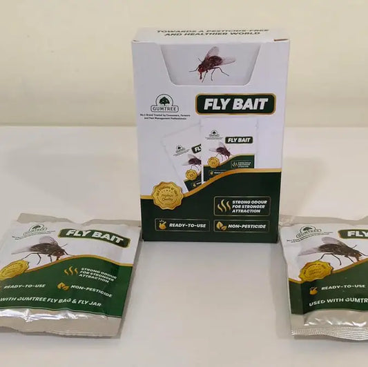Two packages of fly bait on a white surface with a box labeled 'Fly Bait' in the background.