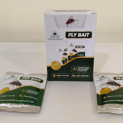 Two packages of fly bait on a white surface with a box labeled 'Fly Bait' in the background.