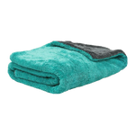 A folded plush fleece blanket in a vibrant teal green with a contrasting dark gray reverse side, shown on a solid white background.